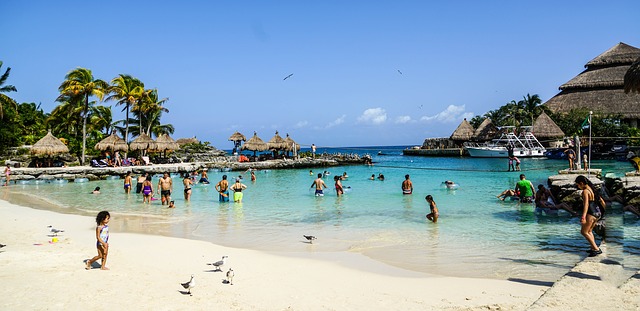 A beach in a Cancun resort, filled with tourists.